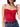 A woman wearing a red matte lace bodysuit with a V-neckline and sleeveless design, paired with blue denim jeans.