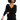 A woman wearing a black boucle long sleeve sweater and matching shorts.