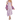 A woman wearing a purple floral dress with long sleeves and a maxi silhouette, paired with tan ankle boots.