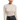 A woman wearing a beige long-sleeve sheer sweater with crystal embellishments and a black leather skirt.